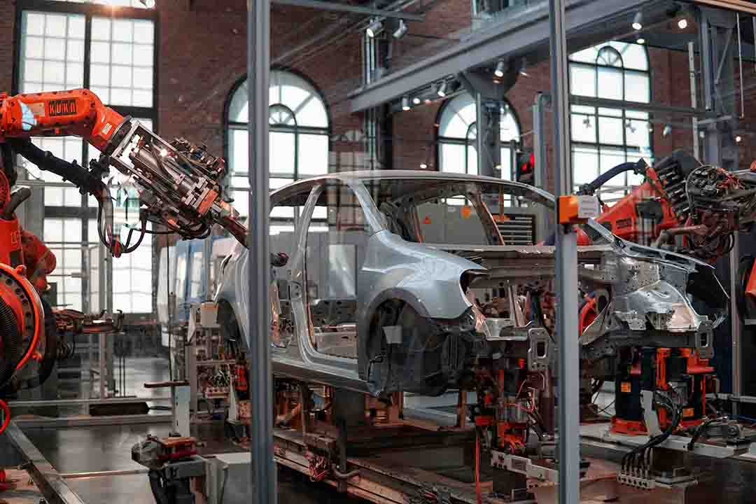 Automotive assembly line with vehicles being built and equipped with motors