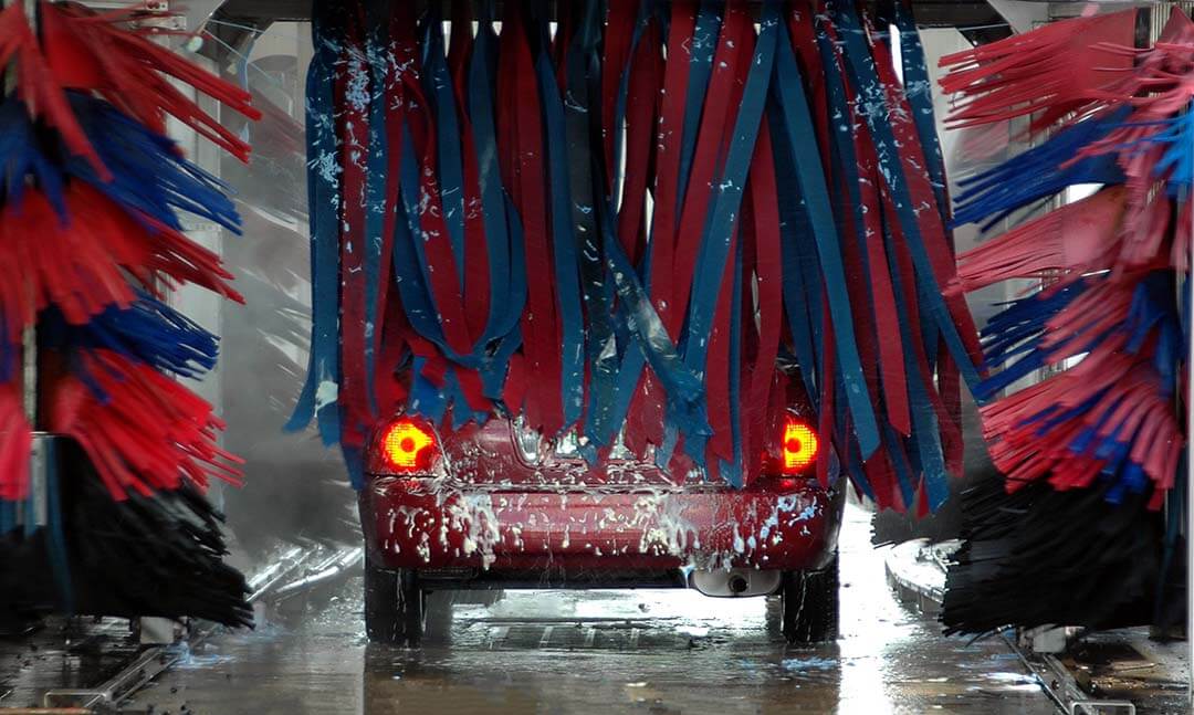 Stock photo of a car going through an automated car wash system