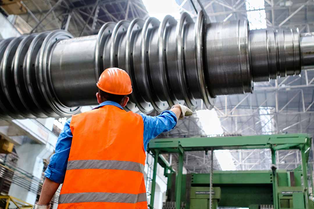 Factory worker manufacturing equipment for industrial and commercial products
